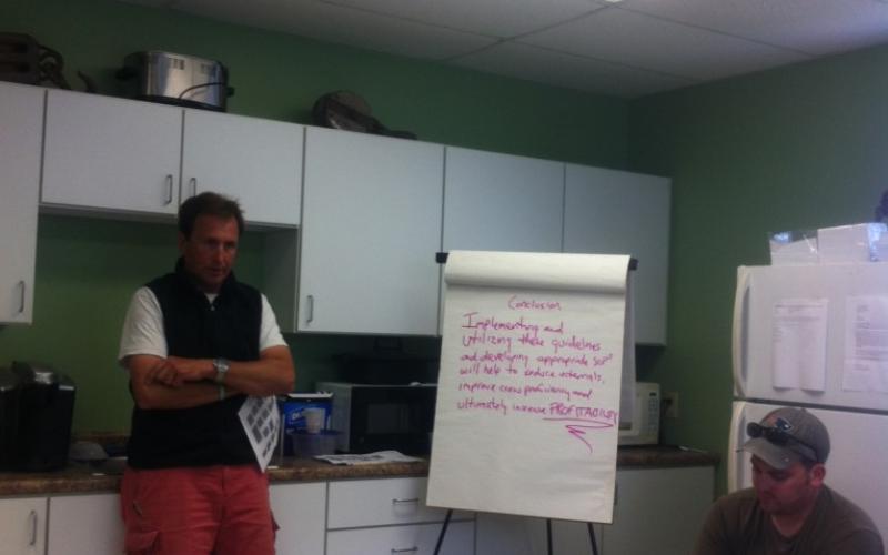 Team members in break room with flip chart